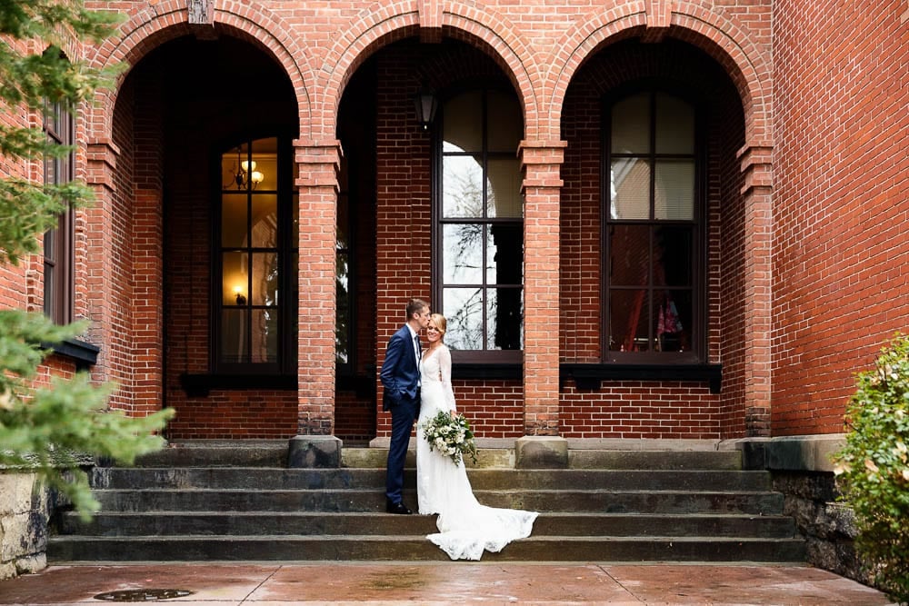 couple picture of bride and groom in stillwater mn red brick background and arch