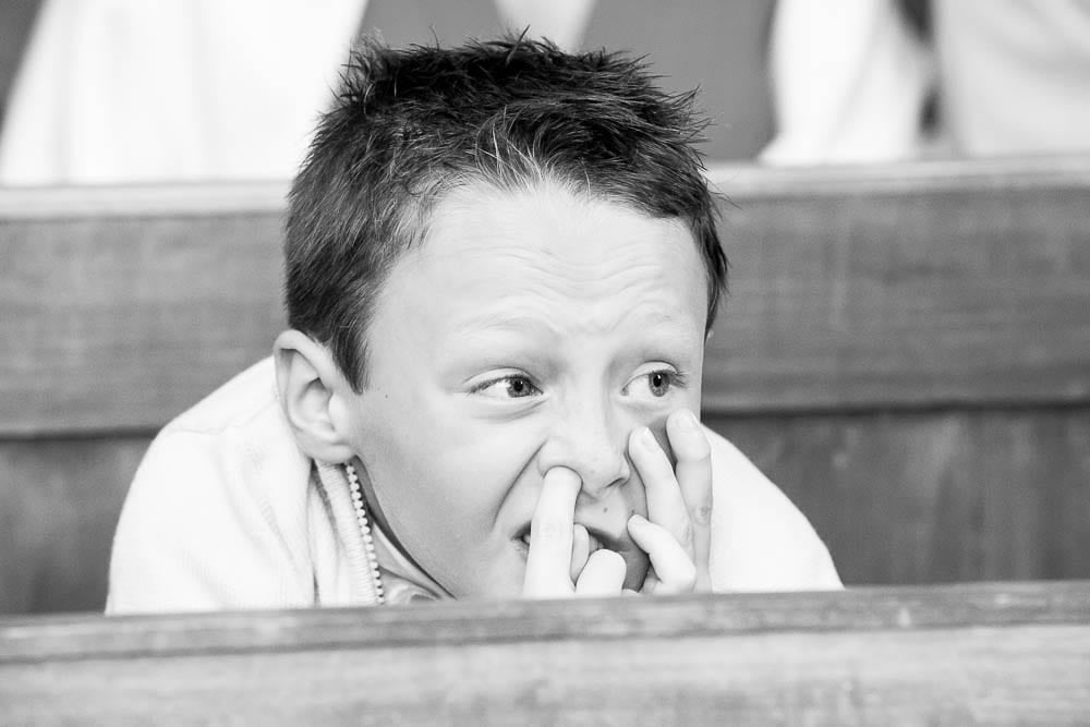 funny candid photograph of a child with his finger in his nose