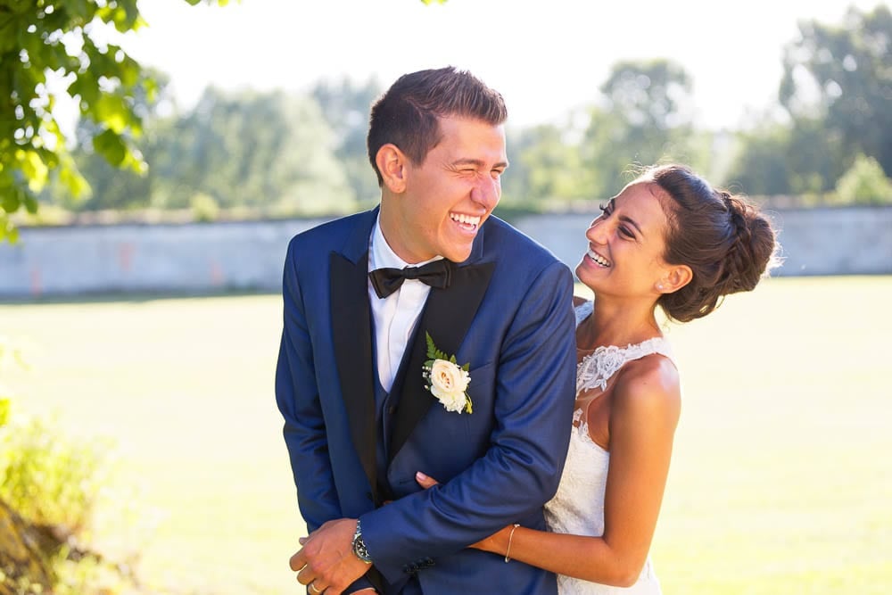 portrait of bride and groom having fun and complicity outside with natural light