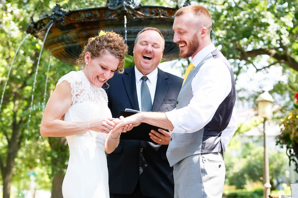 candid and funny shot of bride struggling to put wedding band