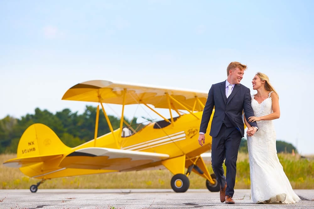 after day session bride and groom on local airport yellow plane