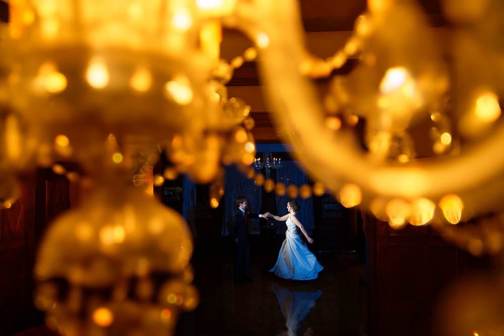 bride and groom first dance creative photo trough chandelier