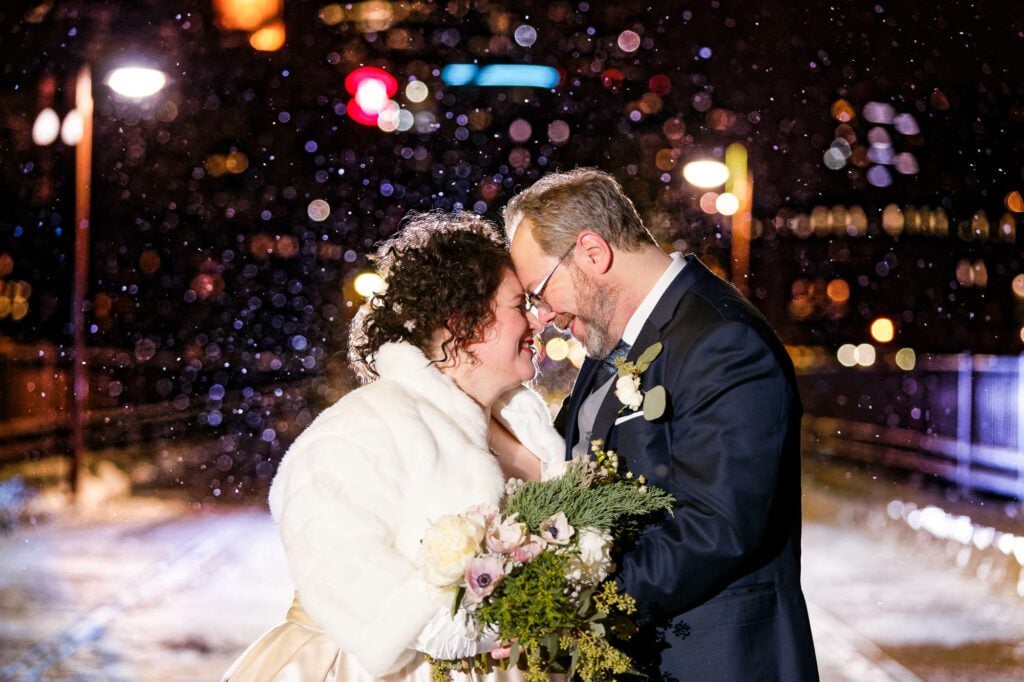 bride-and-groom-snowfall-on-stone-arch-bridge