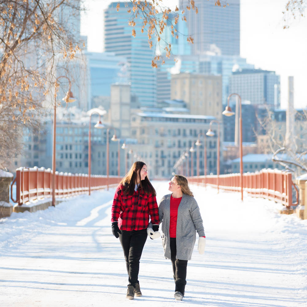 couple dressed red grey and black on white snow