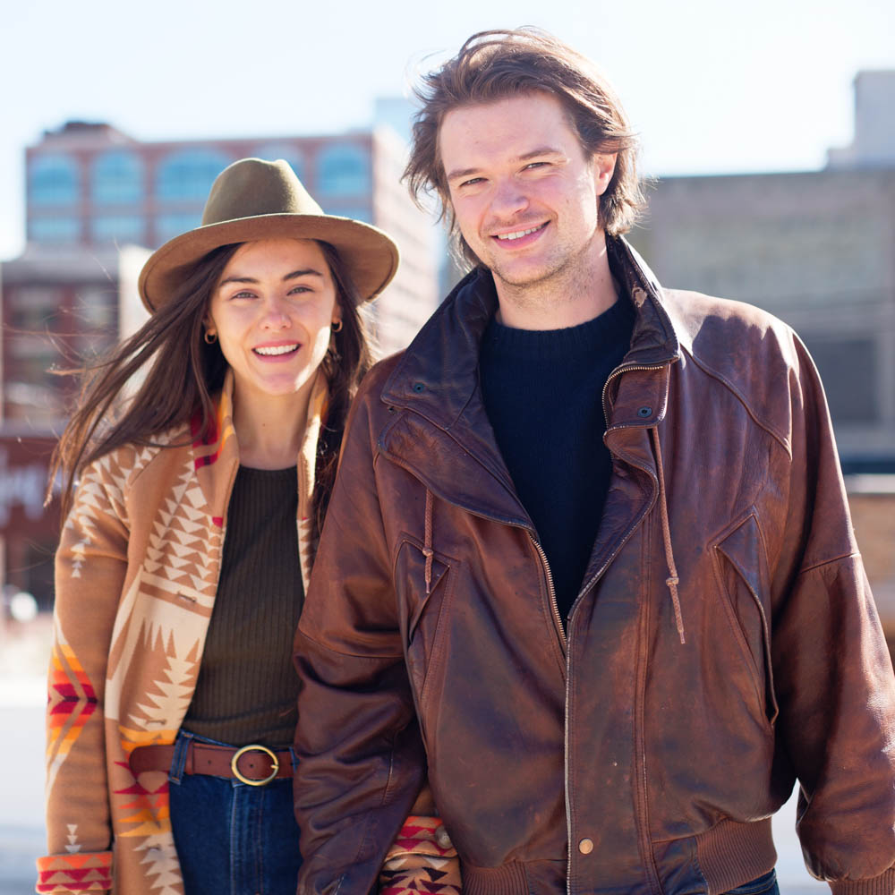 couple dressed with hat and leather jacket