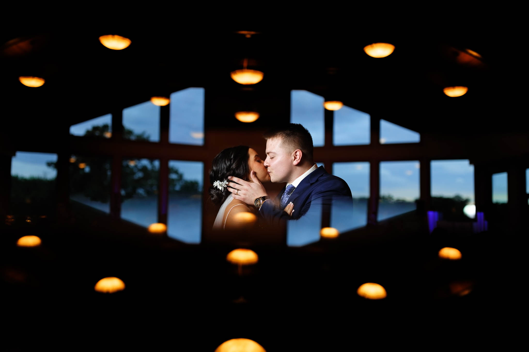 creative portrait of bride and groom kissing at farway