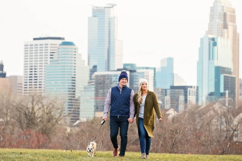 boom island engagement session couple walking on with dog