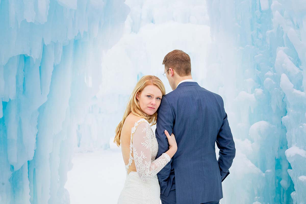 bride-looking-at-the-photographer-in-ice-backdrop-environement-
