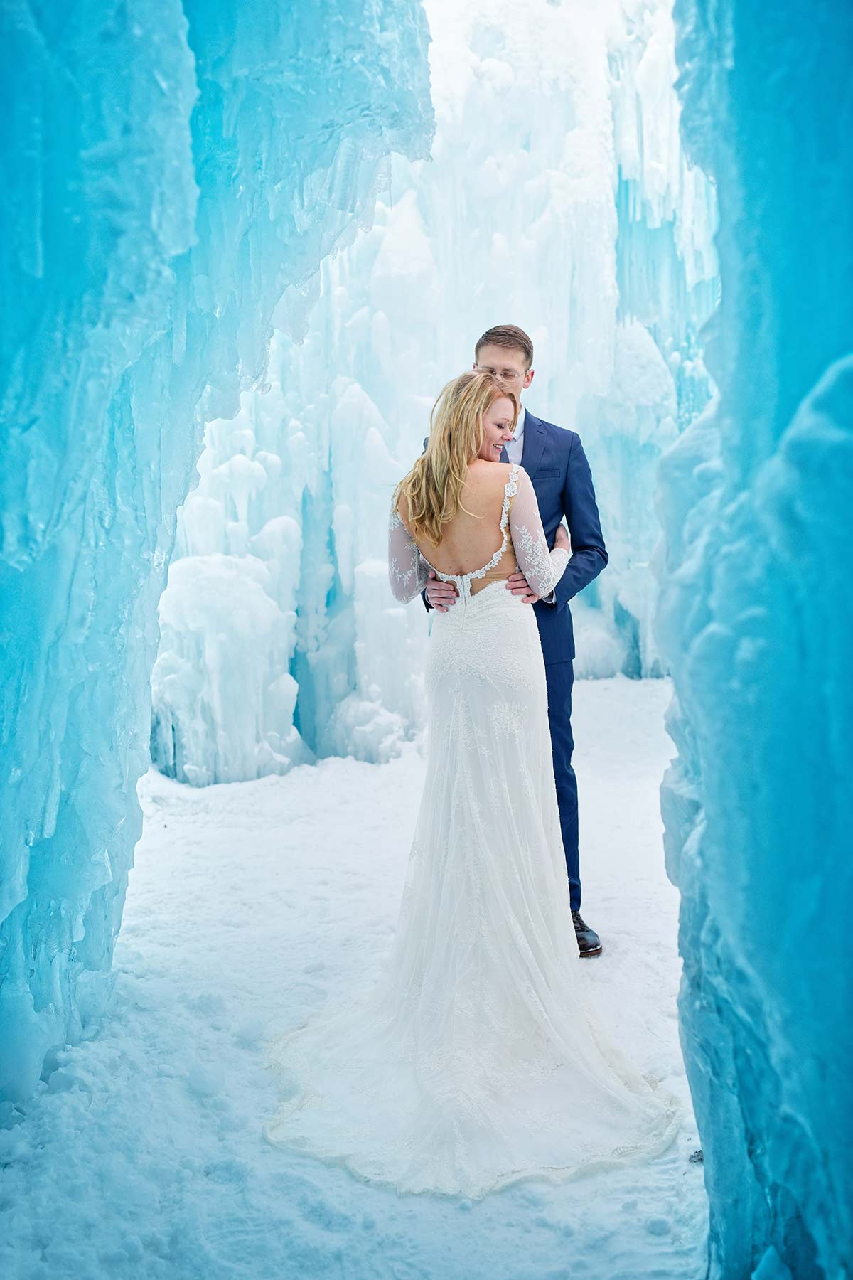 couple-and-back-of-wedding-dress-at-ice-castle-photo-session-minnesota