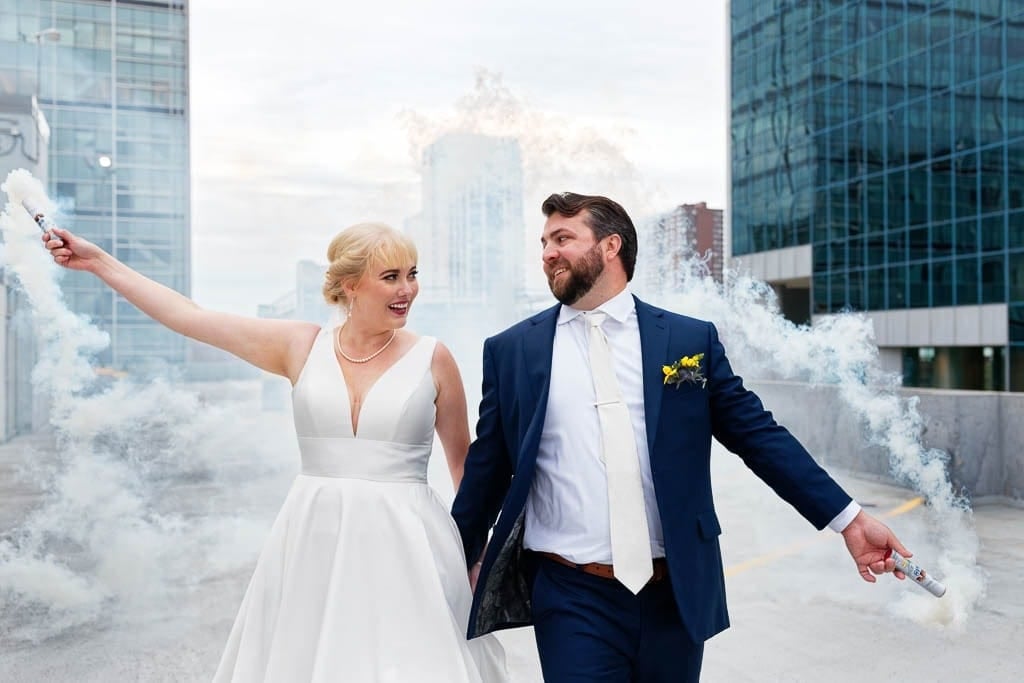 minneapolis rooftop couple playing with smoke bomb