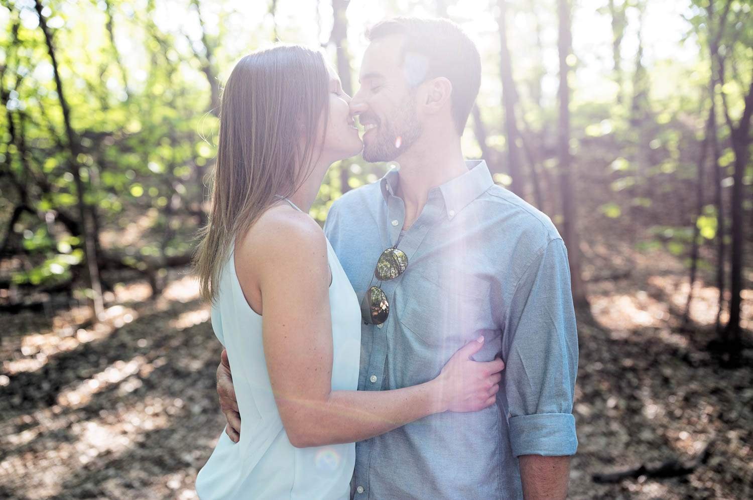 couple kissing at minnehaha dog park in forestry