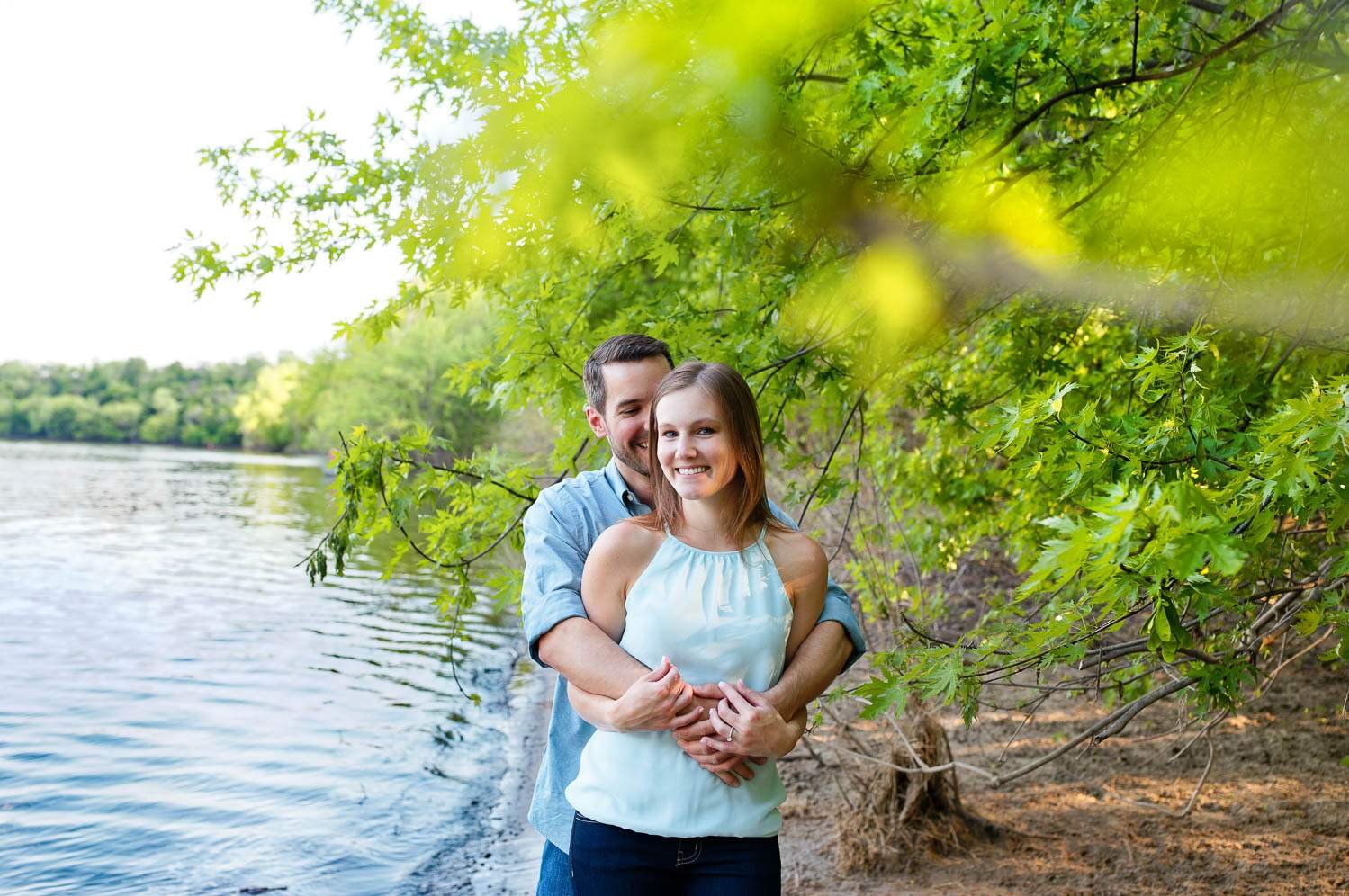 cute couple on mississippi river shore at minnehaha dog park recreation aera