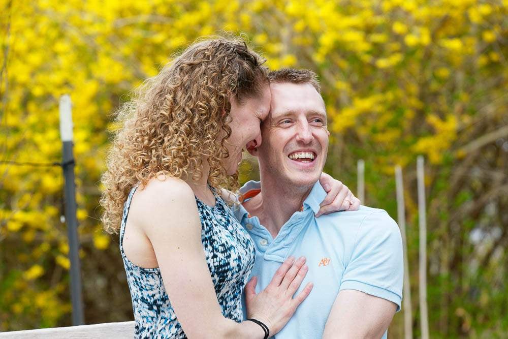 — couple hugging with yellow flowers at minnesota landscape arboretum —