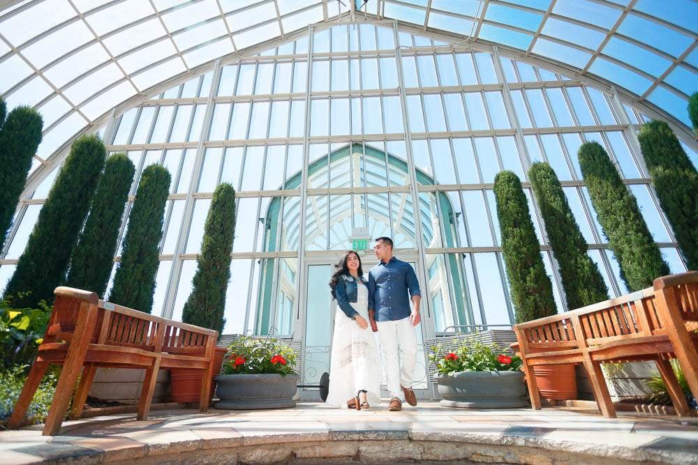 couple in green house with blue sky 