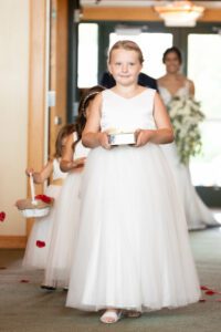 flower girl walking down the aisle