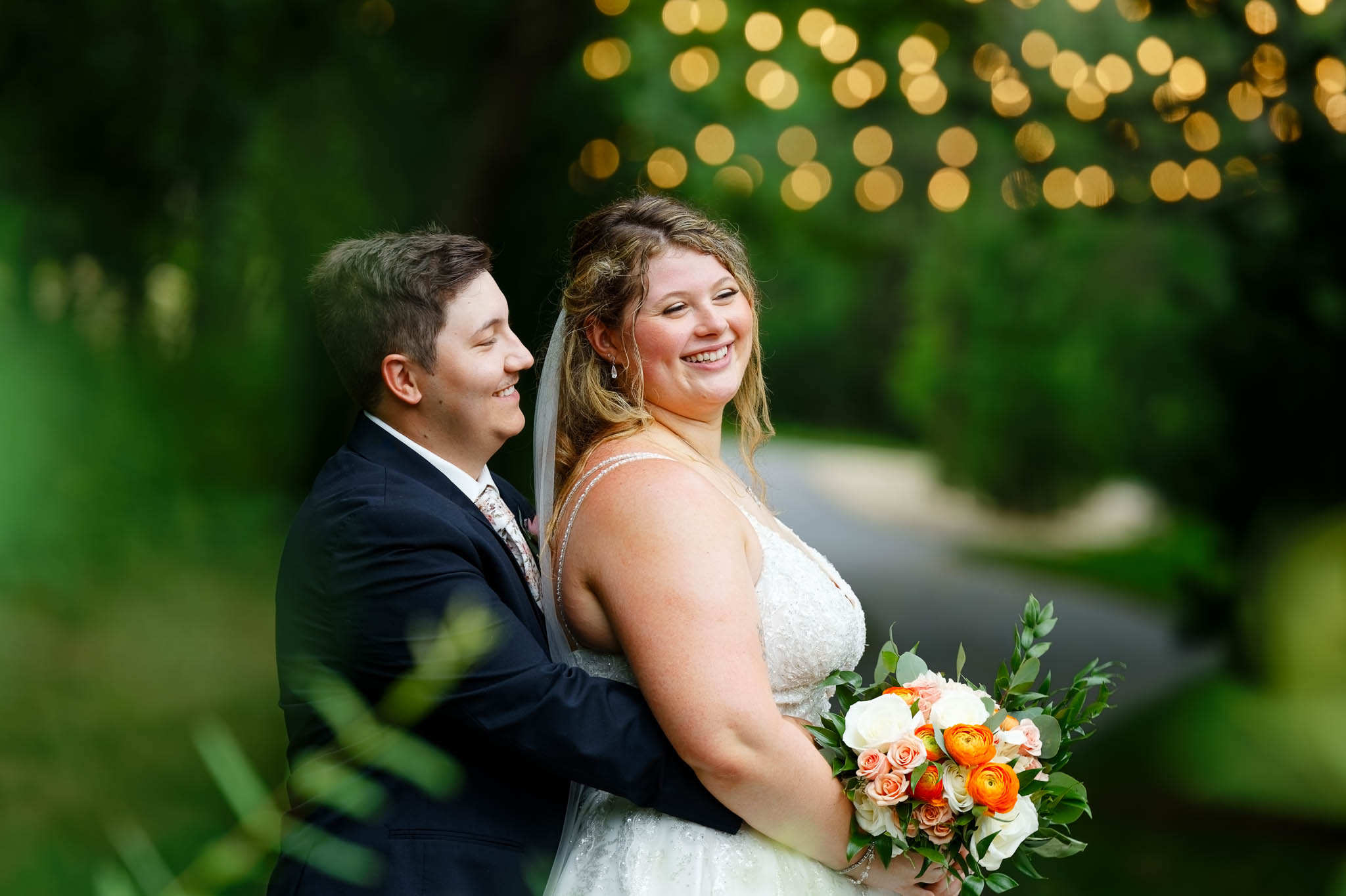 bride and groom with string lights
