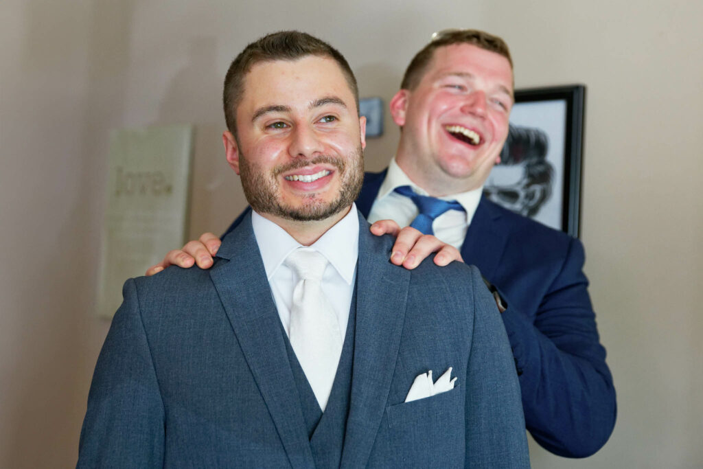 Nervous groom getting ready in his own room with his best man