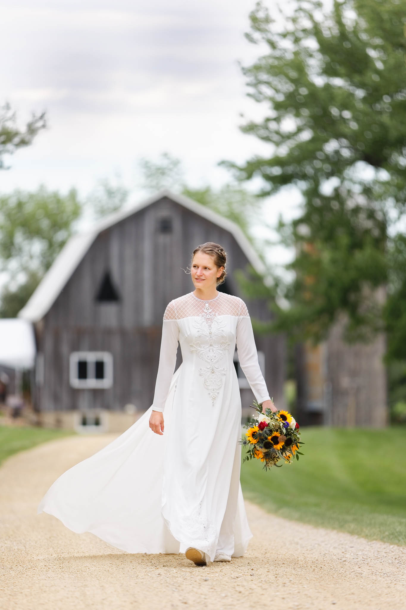 bride individual with pond view barn in background