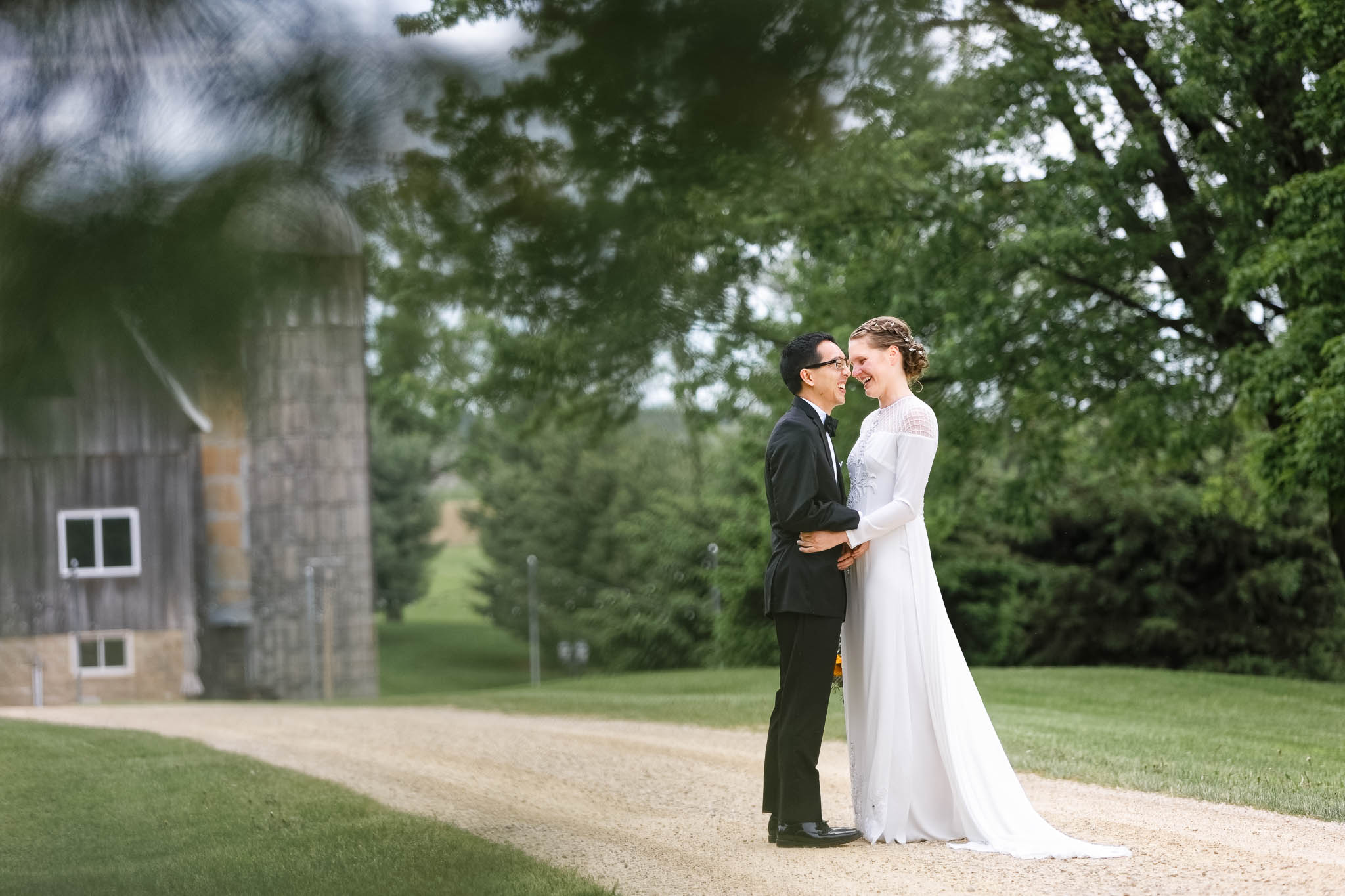 couple with landscape and a bit of barn