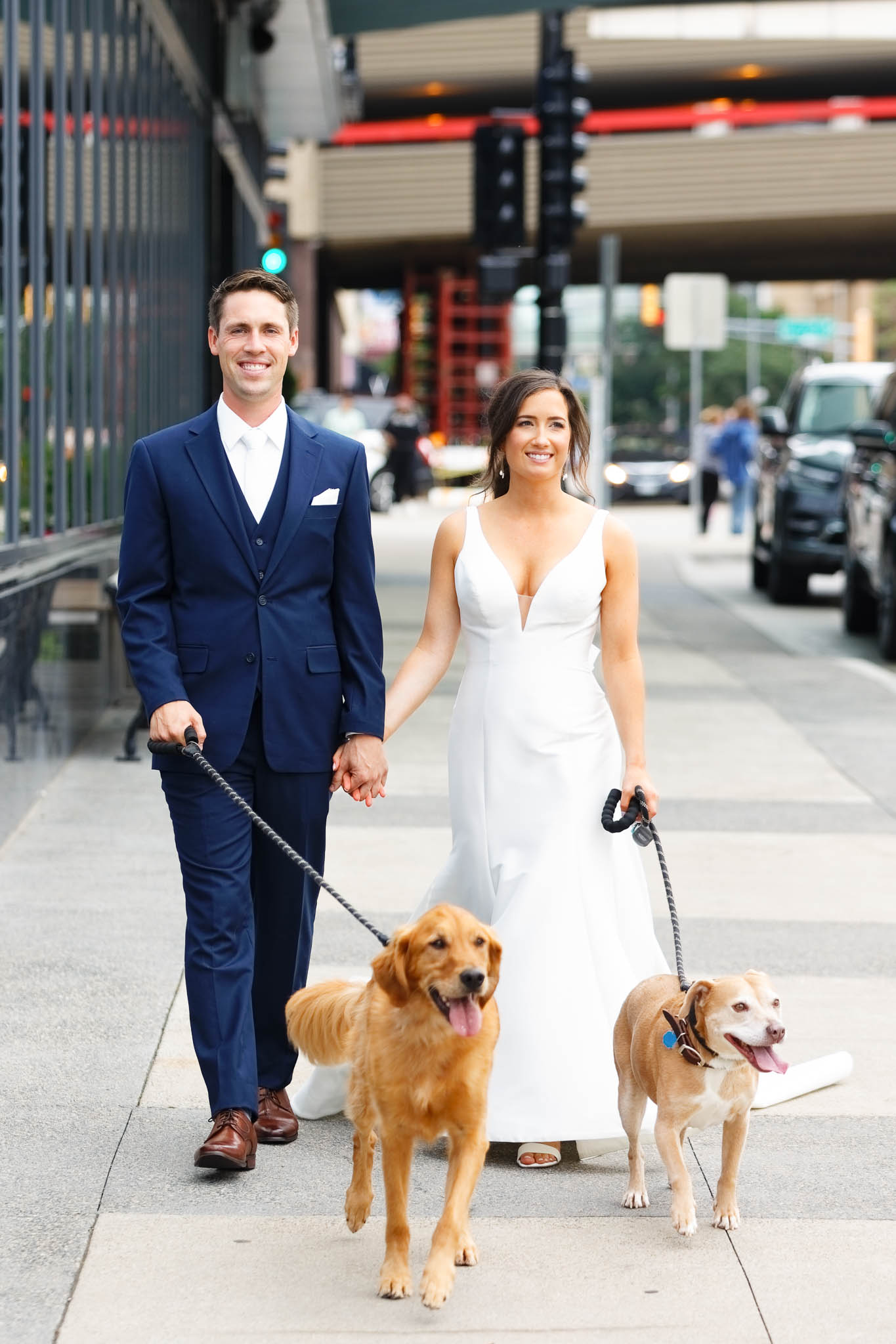 bride and groom walking with dog