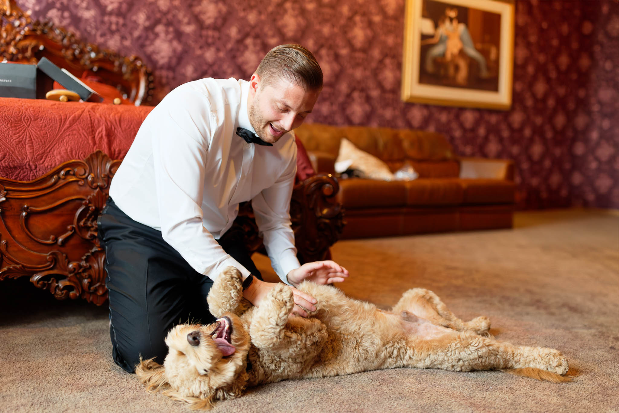 groom playing with its dog during preparation