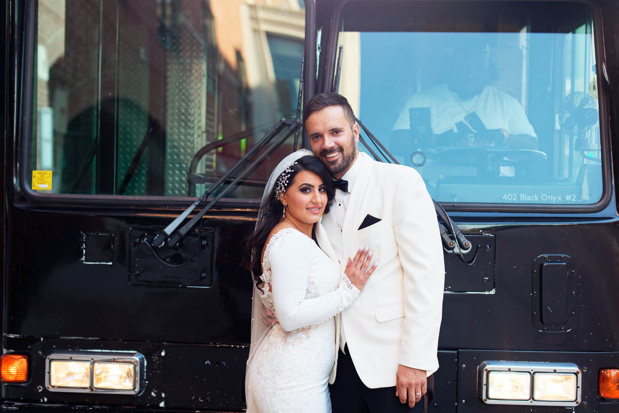 bride and groom with party bus balck onyx 2
