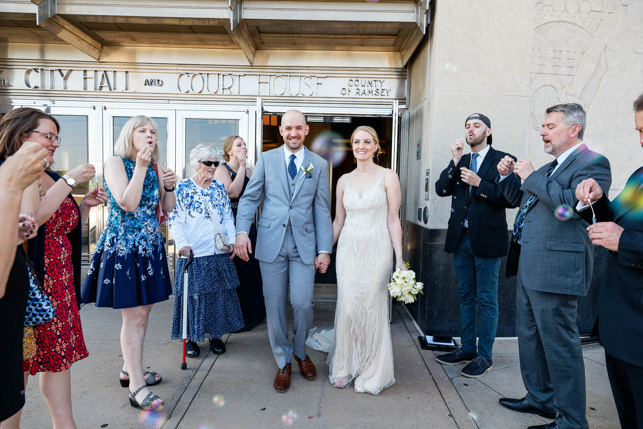 Exit courthouse with guests blowing bubbles