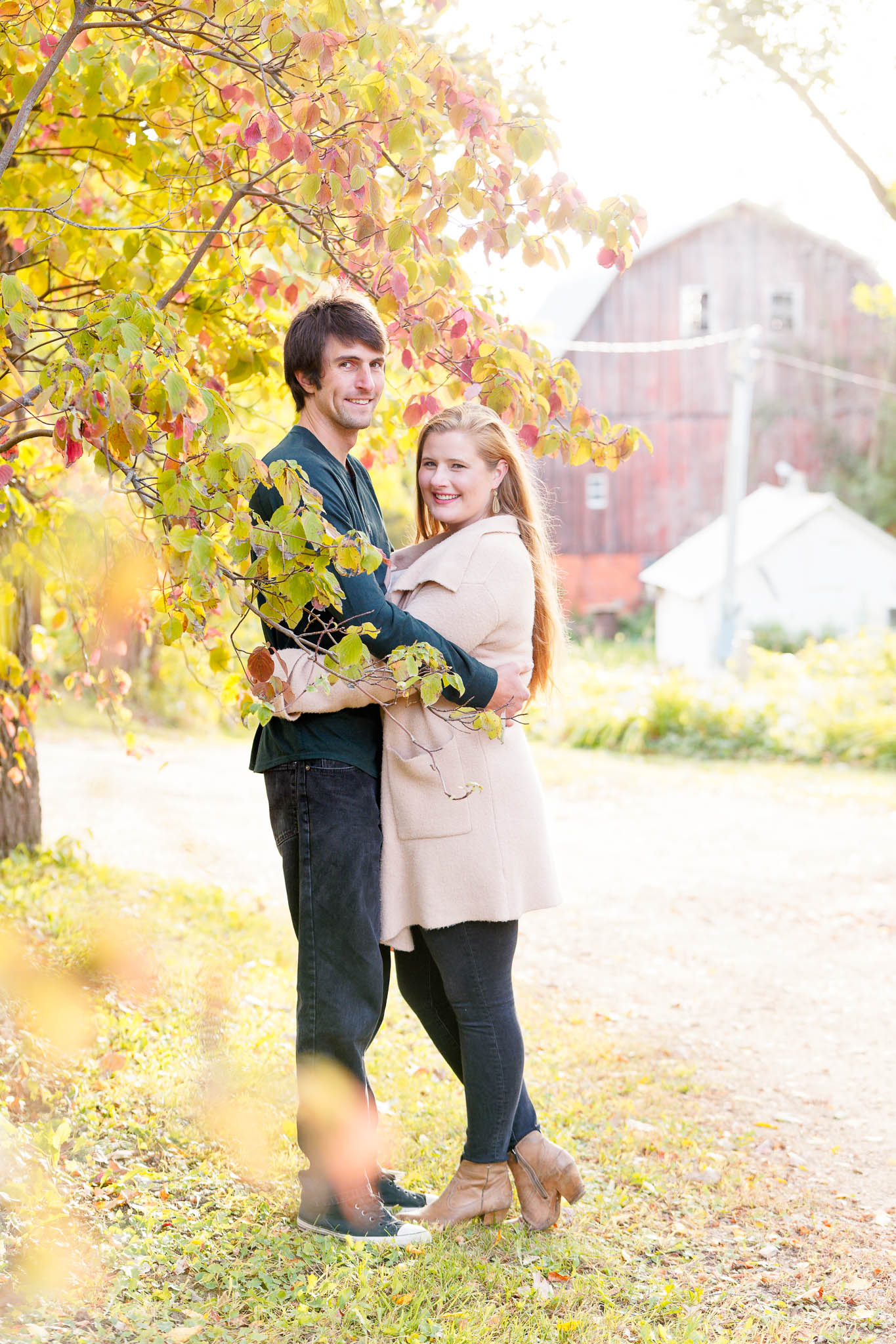 fall engagement photo shoot with red barn in the back-2