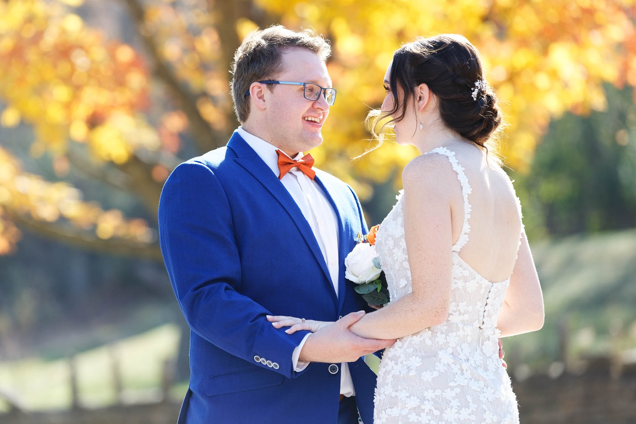 Bride and groom first look in front of yellow leaves mapple tree_