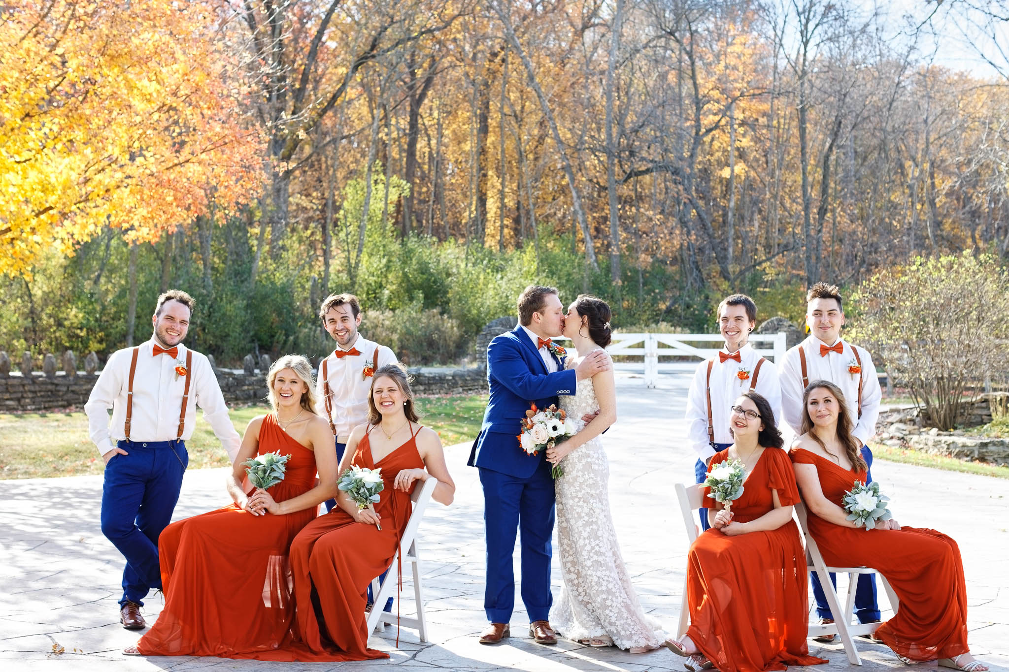 wedding party fall colors orange dresses and blue suit