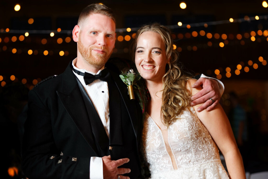 Bride and groom portrait with string light