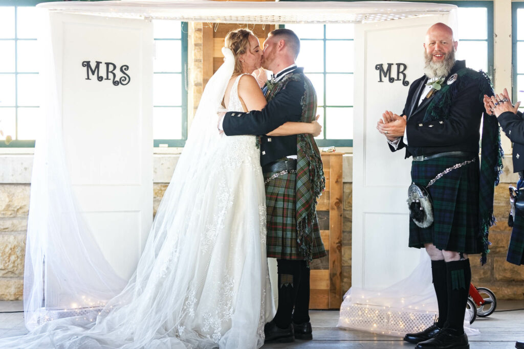 couple kissing wedding ceremony rochester florall hall historic venue