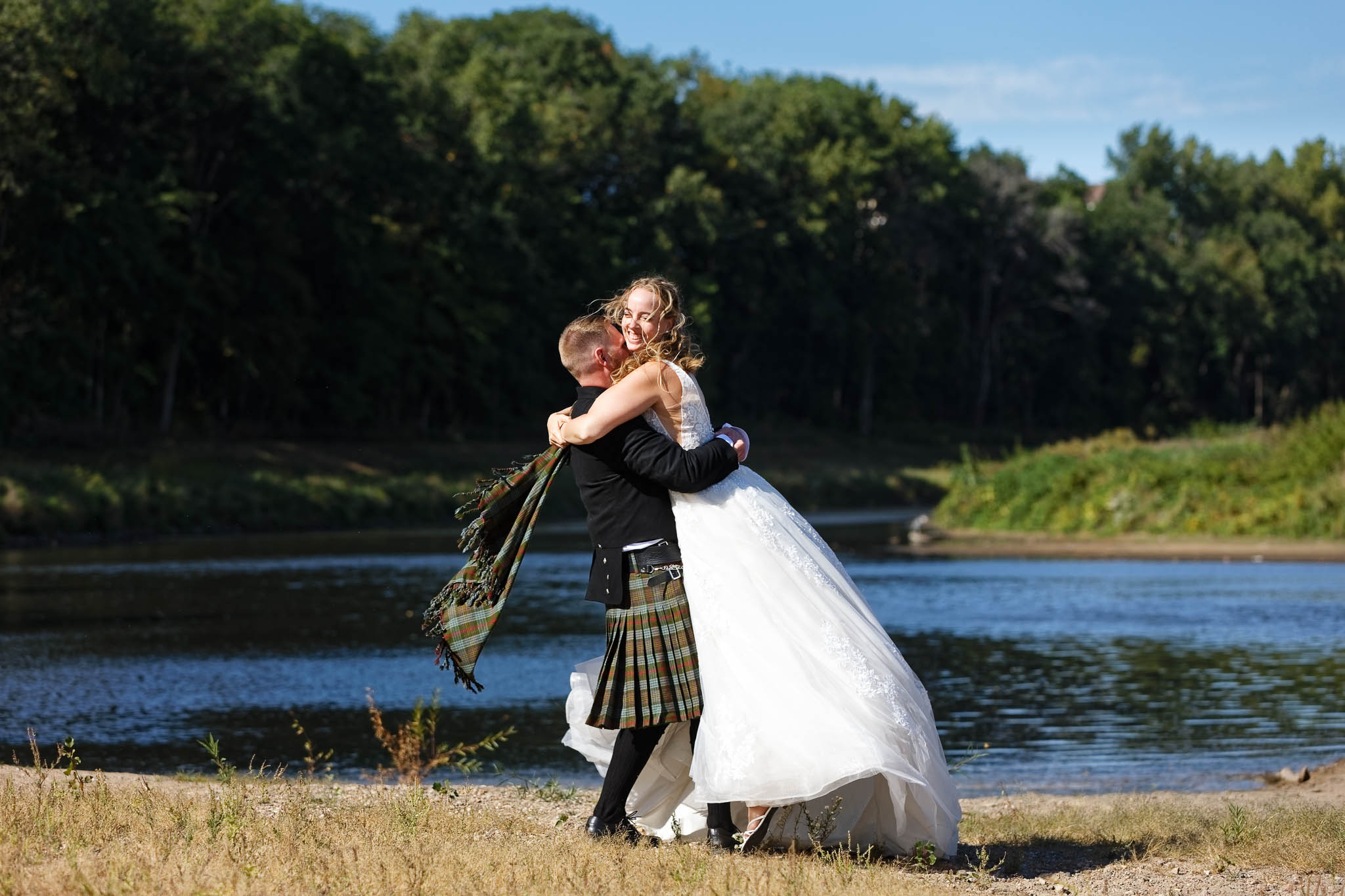 Wedding Photo off the married couple in front of the Zumbro River Rochester Thomson Mill Race Park