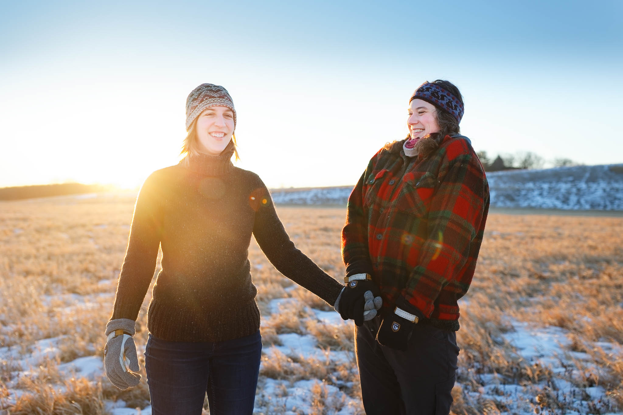 Same-sex engagement session winter frozen lake