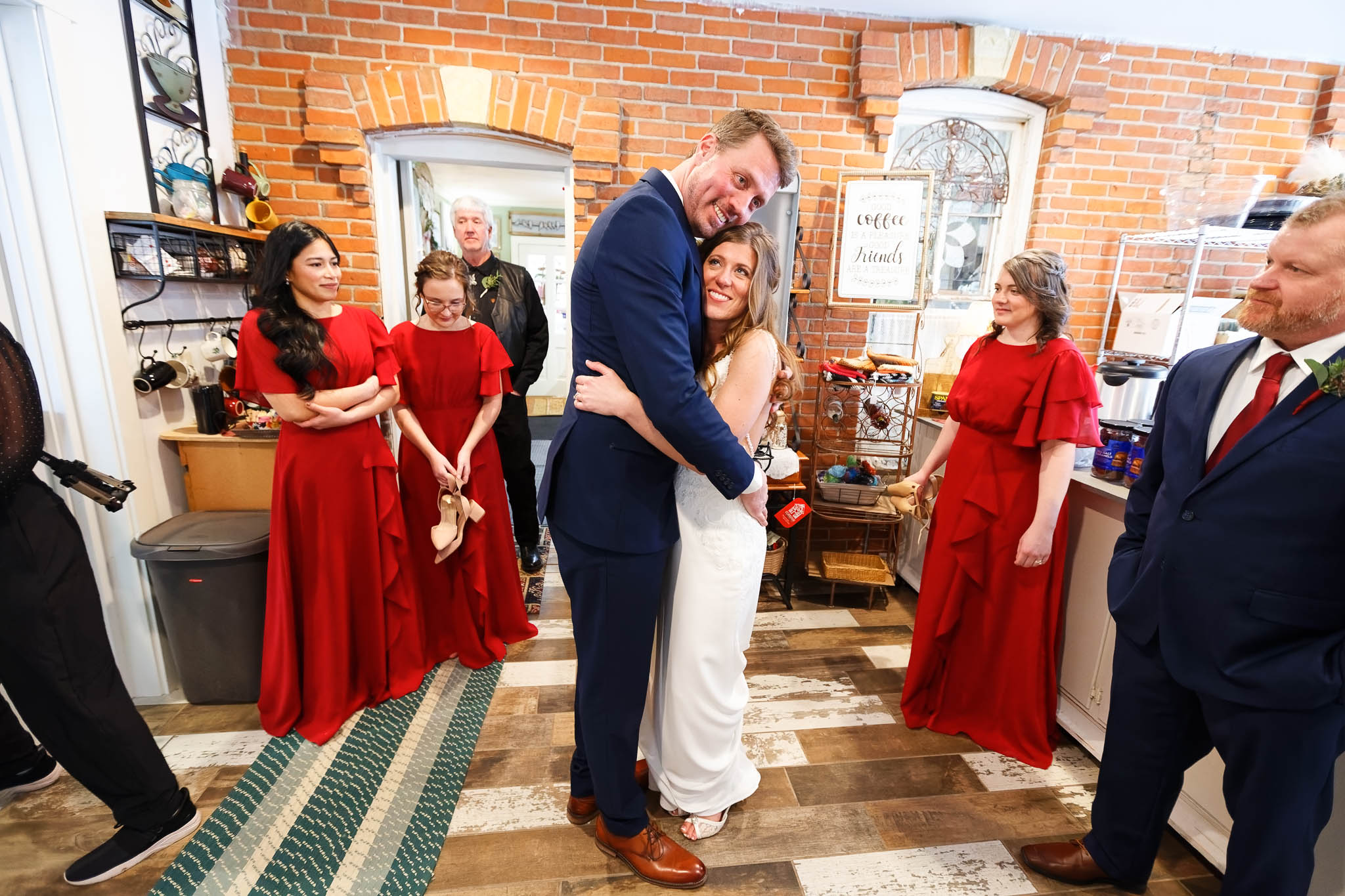 Bride and groom and their wedding party in the kitchen