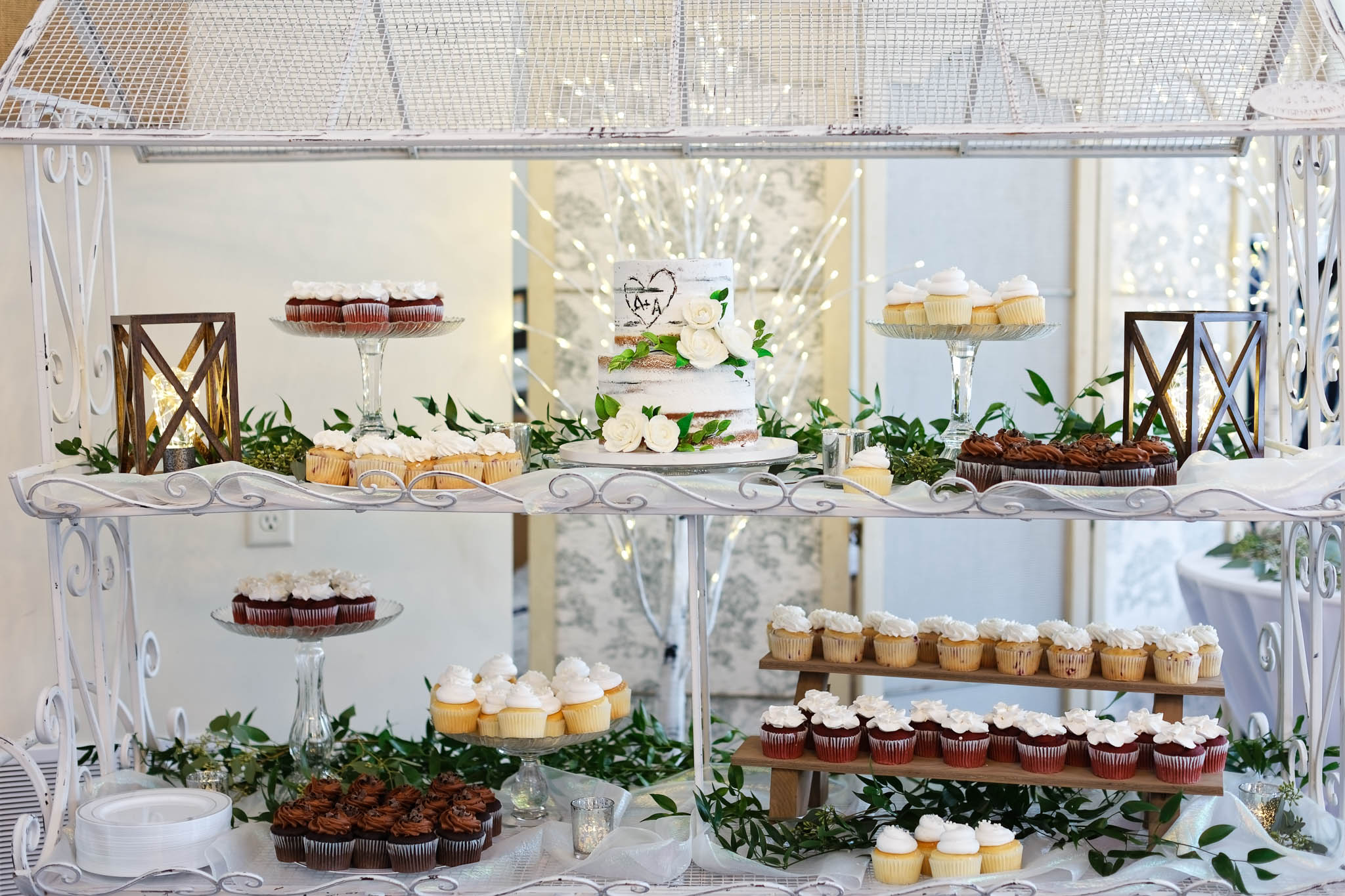 Wedding cake and wedding desserts in metallic cart
