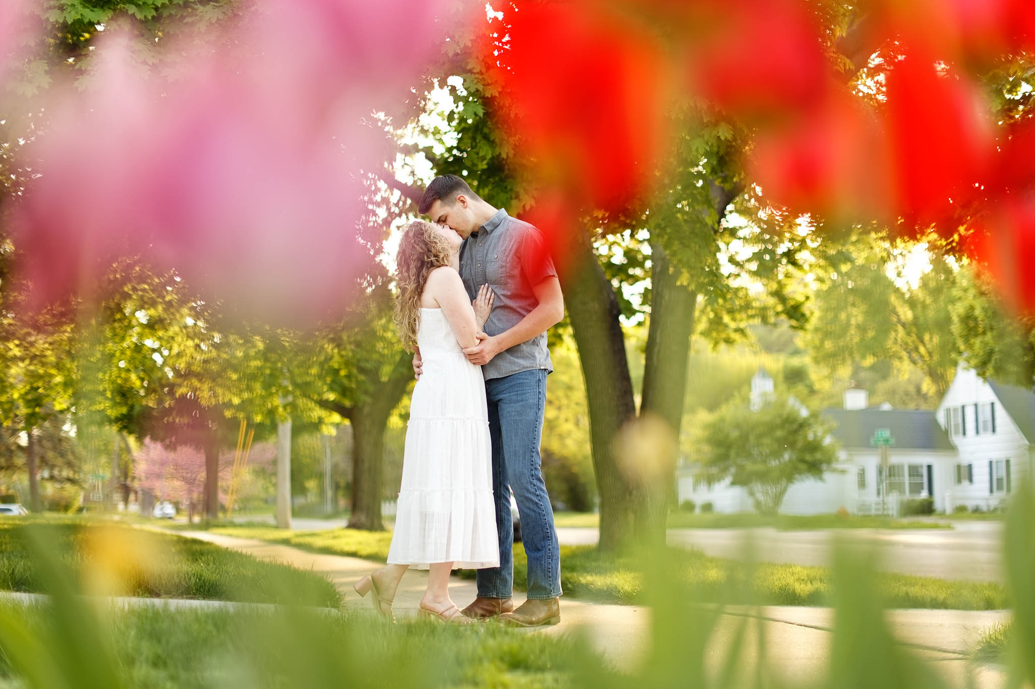 Engagement photo true tulips of a couple kissing in the historic south east Neighbourhood in Rochester, Minnesota