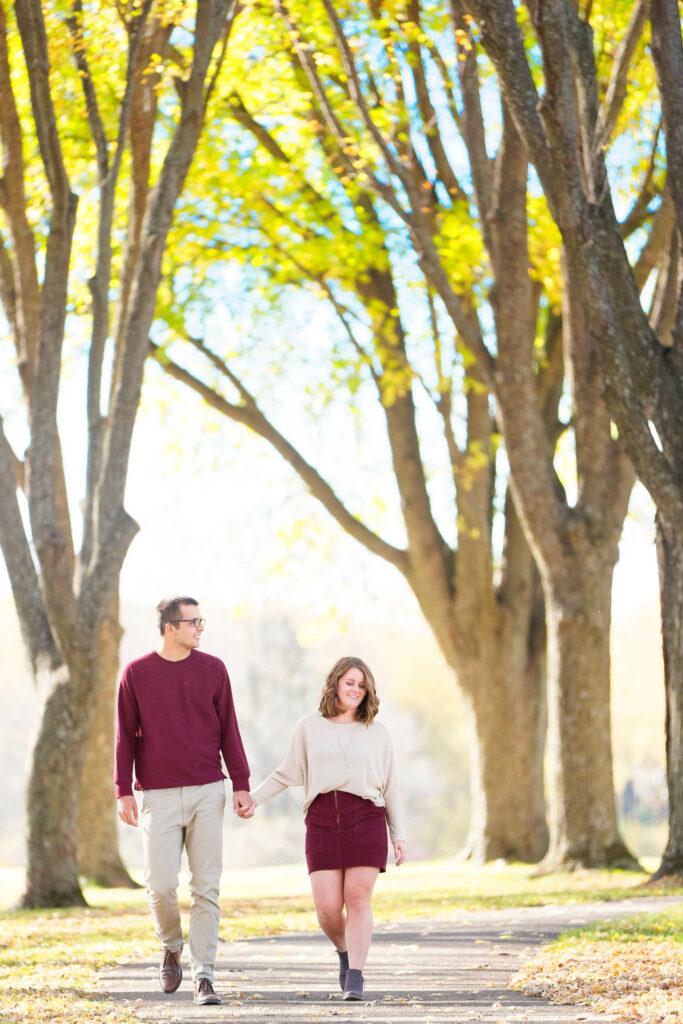 Couple session walking under maple tree fall season