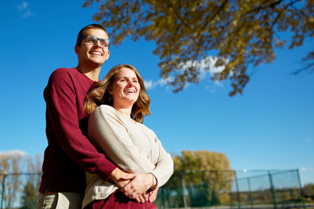 Engagement photo of couple with blue sky