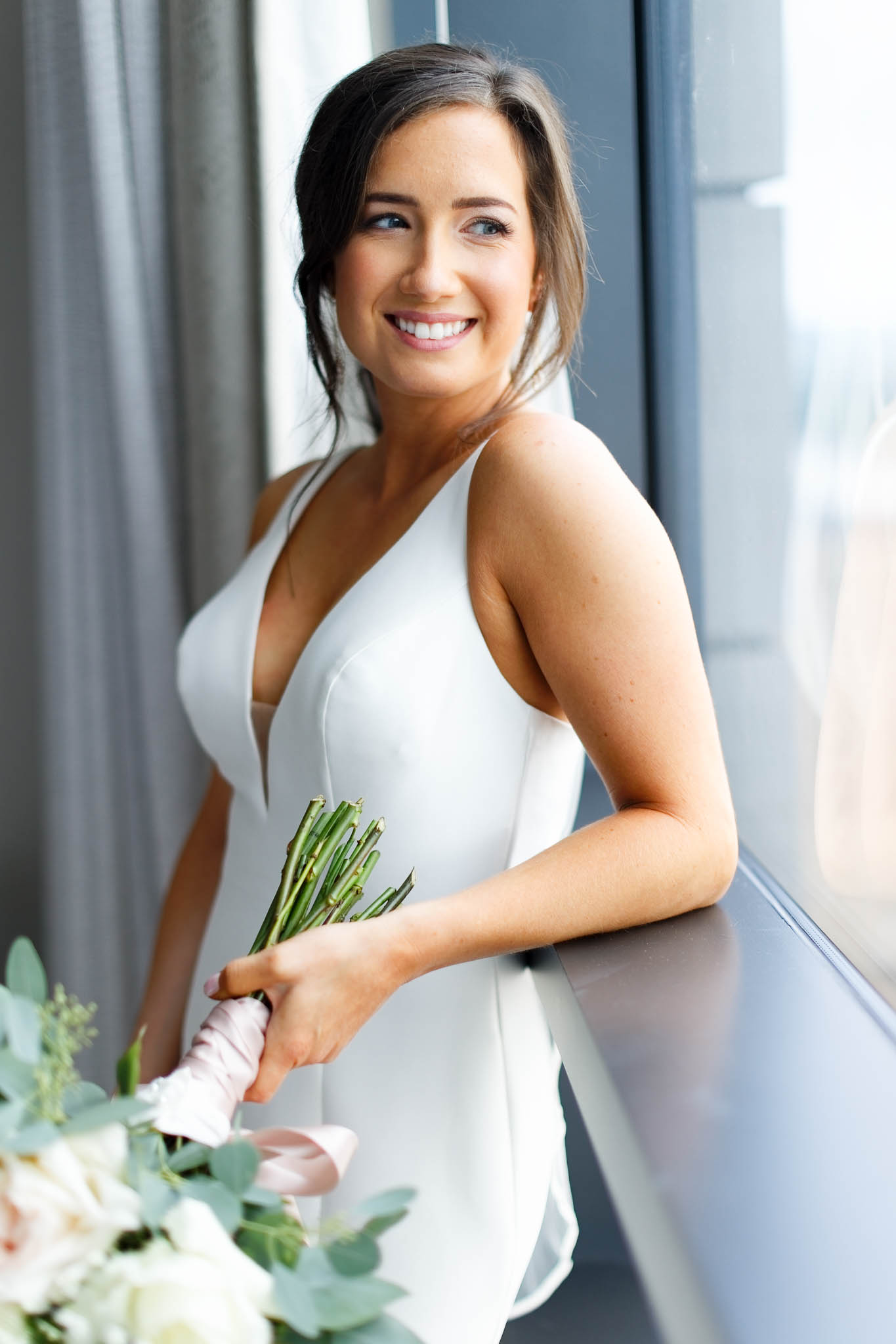 bride getting in her dress at hilton suite-2
