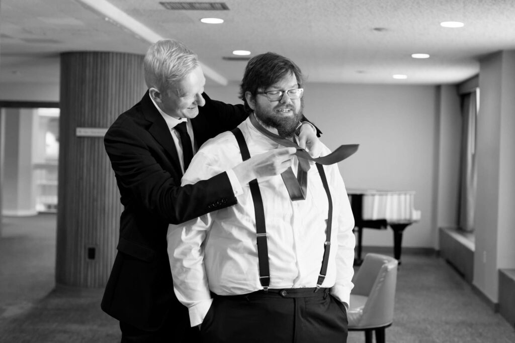 Groom, helping his best man to tie his tie