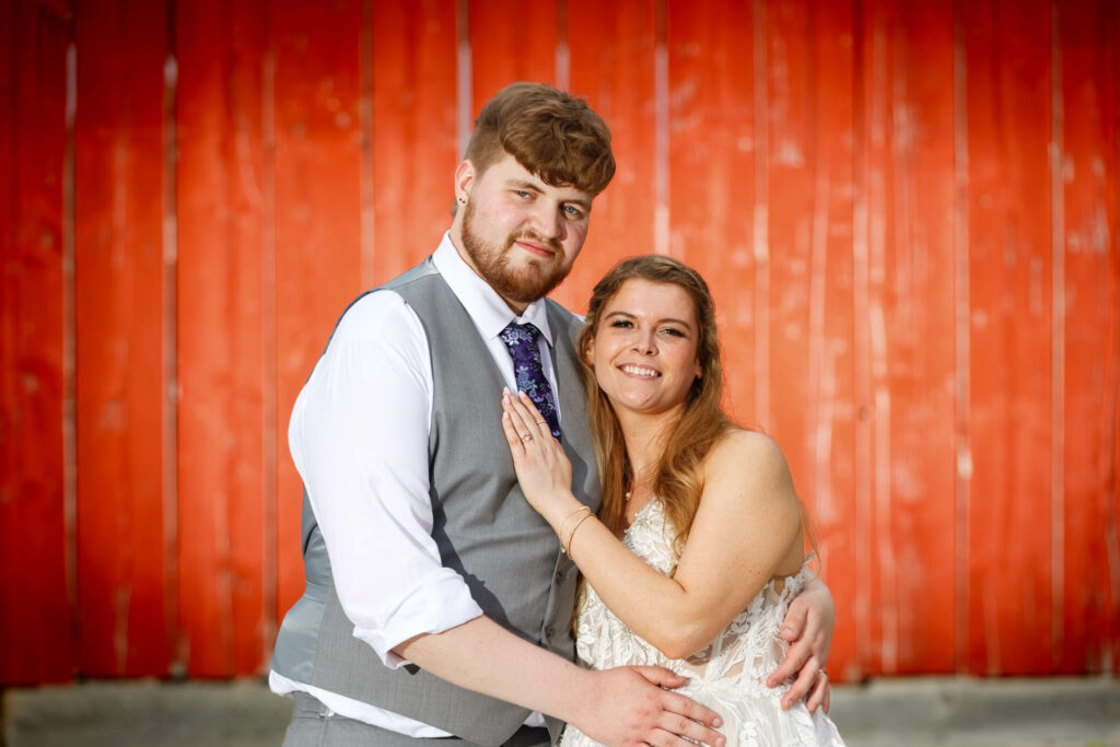 072-Creative shot of the bride and the groom with red barn at mayowood stone barn