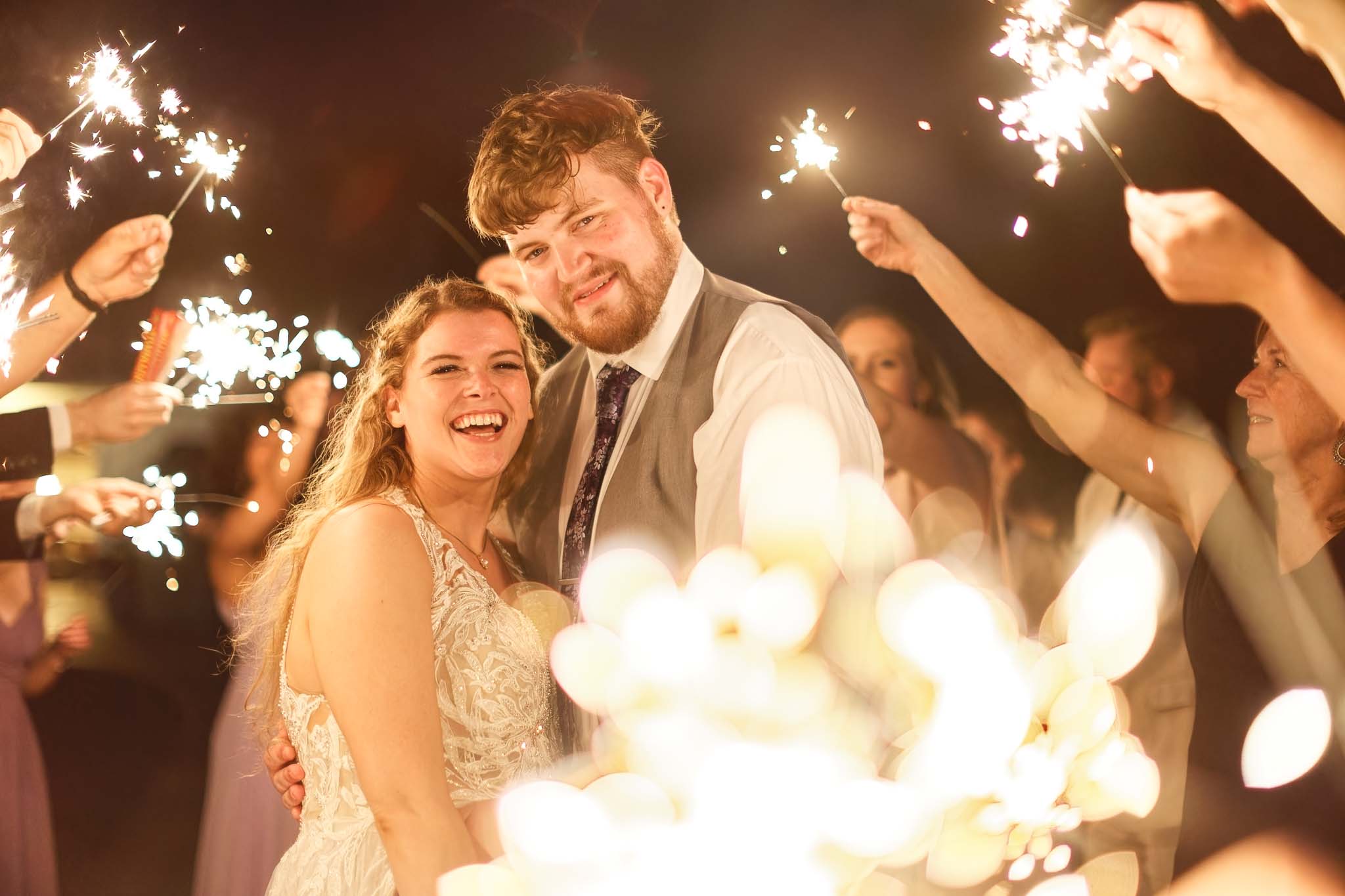 092-Bride and groom grand exit with sparklers at mayowood stone barn