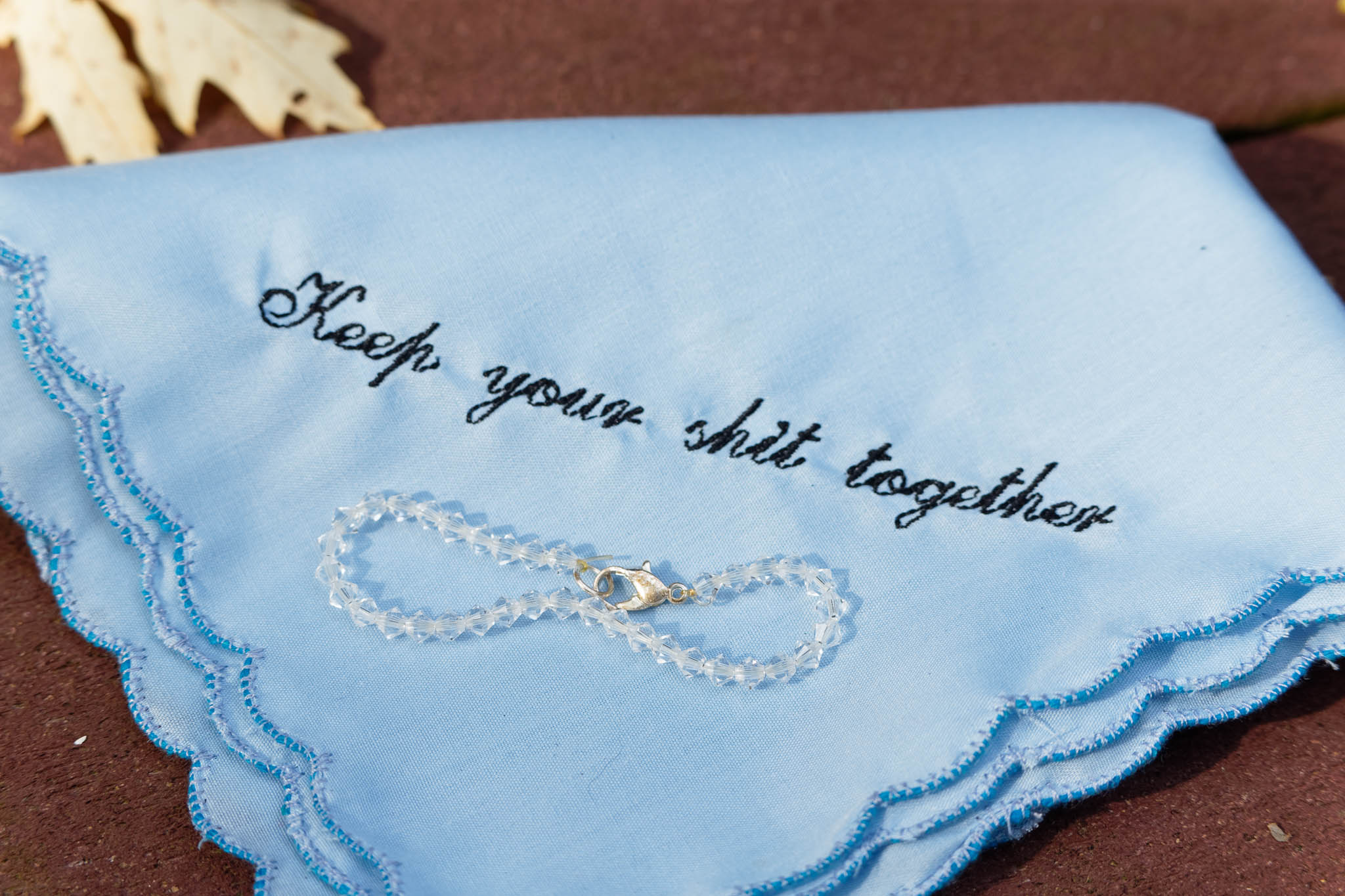 blue handkerchief with written keep your shit toether