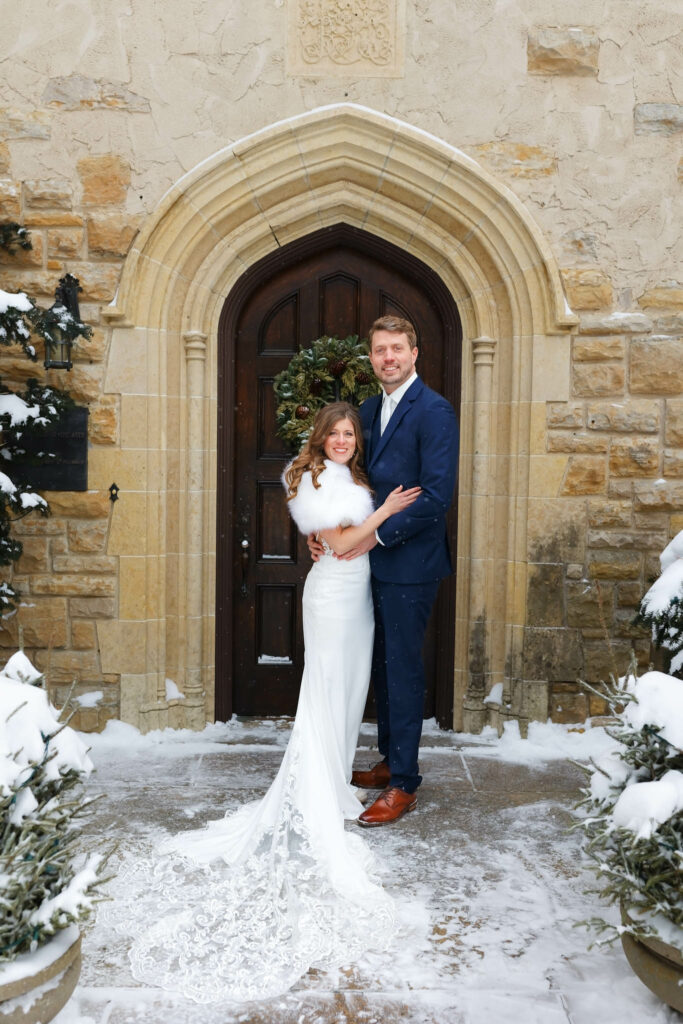 Bride and groom in front of the Tudor revival mansion main door