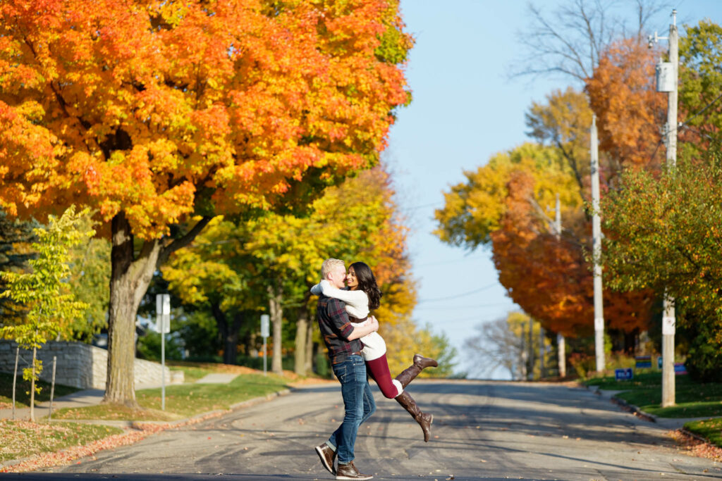 Couple having fun during fall photo session in Rochester streets