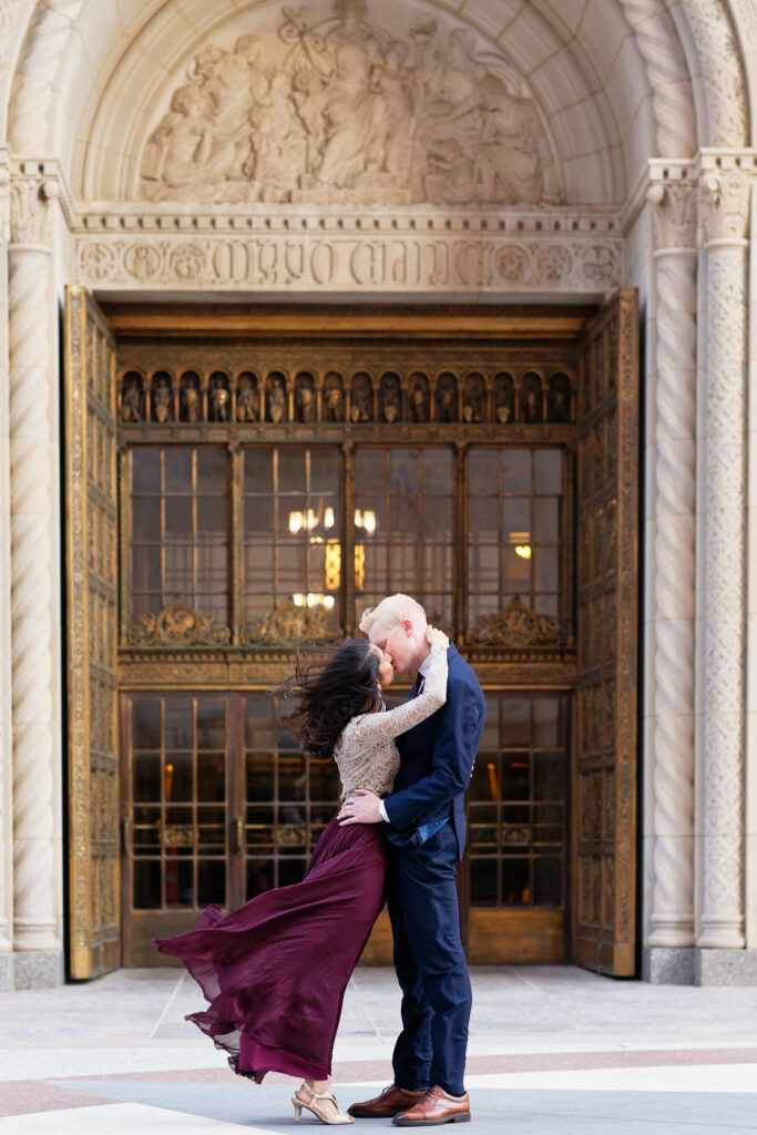 couple kissing in front of Plummer Building Cooper door