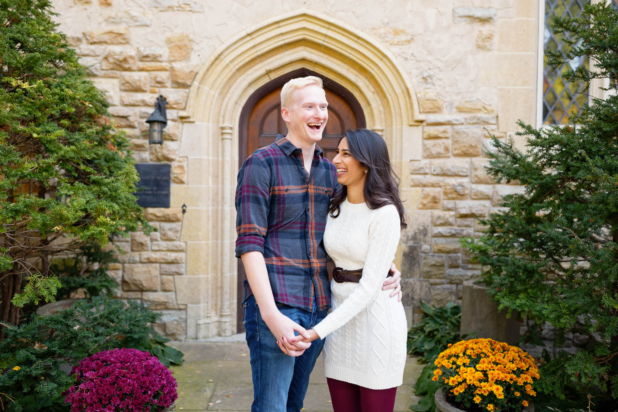 Engagement session at Plummer House in front of the gothic wood door