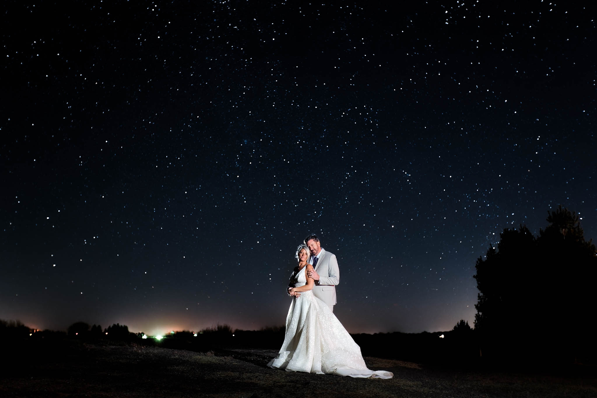 night picture with stars of bride and groom at pond view barn