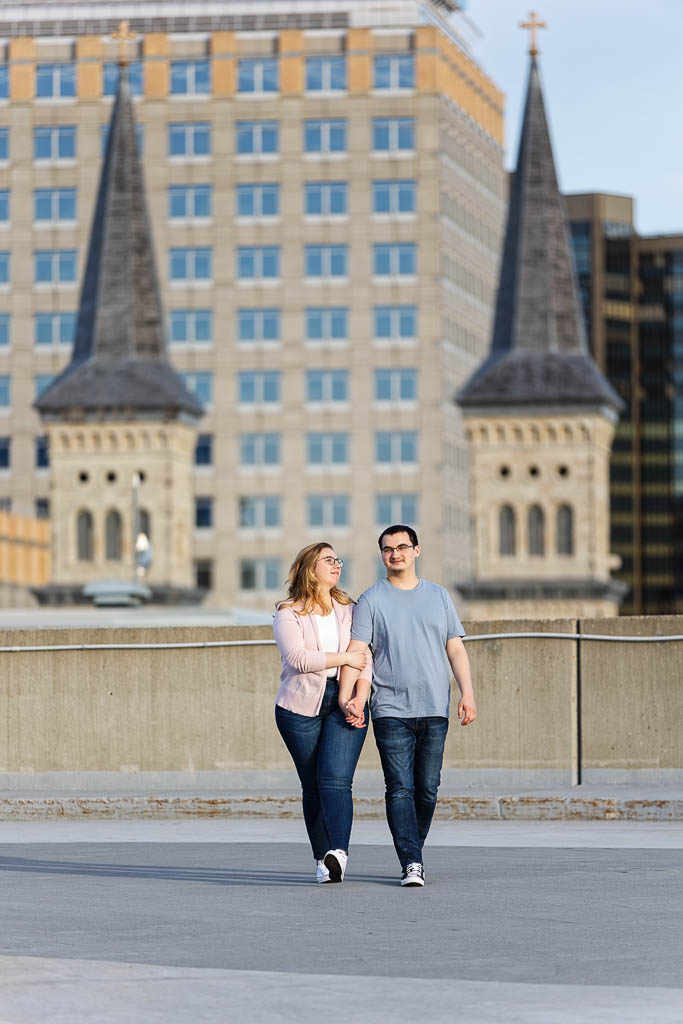 engagement photo rooftop with church of the assumption towers in the background